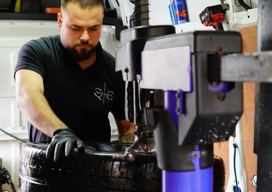 QuickGrip technician fitting a tyre on the in-van machine